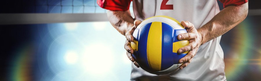 sportsman-holding-volleyball-against-view-spotlights.jpg